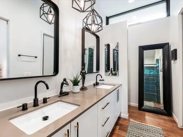 a bathroom with a double vanity sink and a mirror
