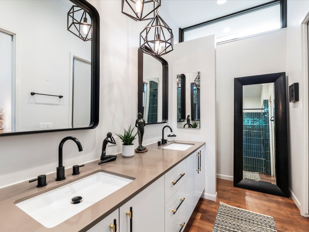 1703 Dexter Street Austin, TX 78704 - Photo 22 of 38 a bathroom with a double vanity sink and a mirror