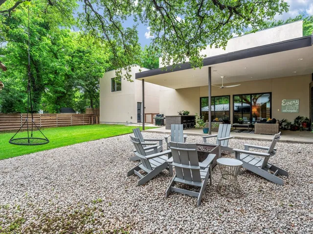 a building outdoor space with patio furniture and garden