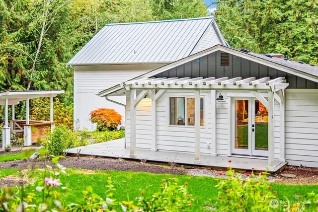 an aerial view of a house with backyard outdoor seating and green space
