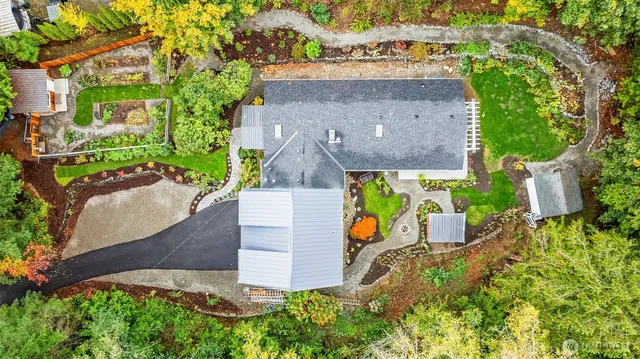 an aerial view of a house with a yard and garden