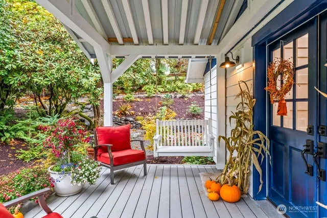 a porch with chairs and wooden floor