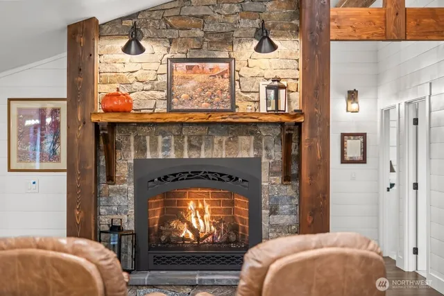 a kitchen with stainless steel appliances granite countertop a refrigerator a sink a stove and white cabinets with wooden floor