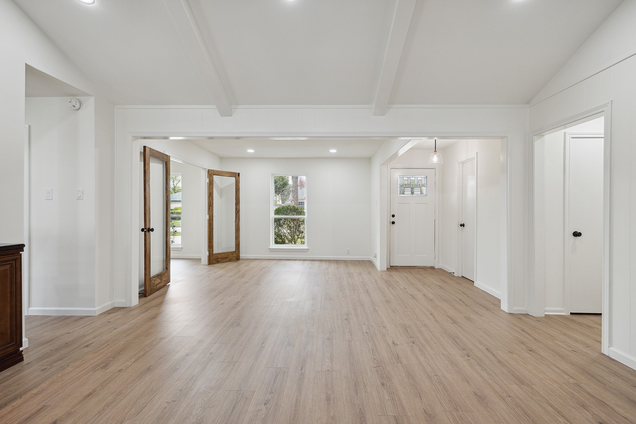 9719 Springmont Drive Houston, TX 77080 - Photo 9 of 32 A view looking back towards the front of the home from the central living space! Continuous wood laminate flooring throughout!! NO CARPET!