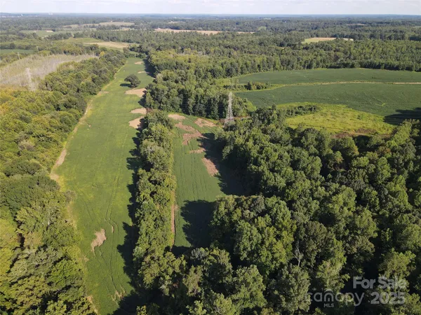 an aerial view of a houses with a yard
