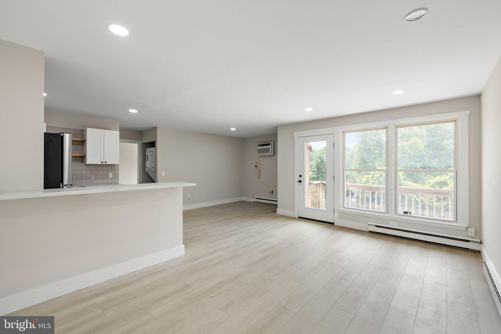 200 Brandywine Boulevard, Unit C7 Wilmington, DE 19803 - Photo 4 of 16 a view of an empty room with wooden floor and a window