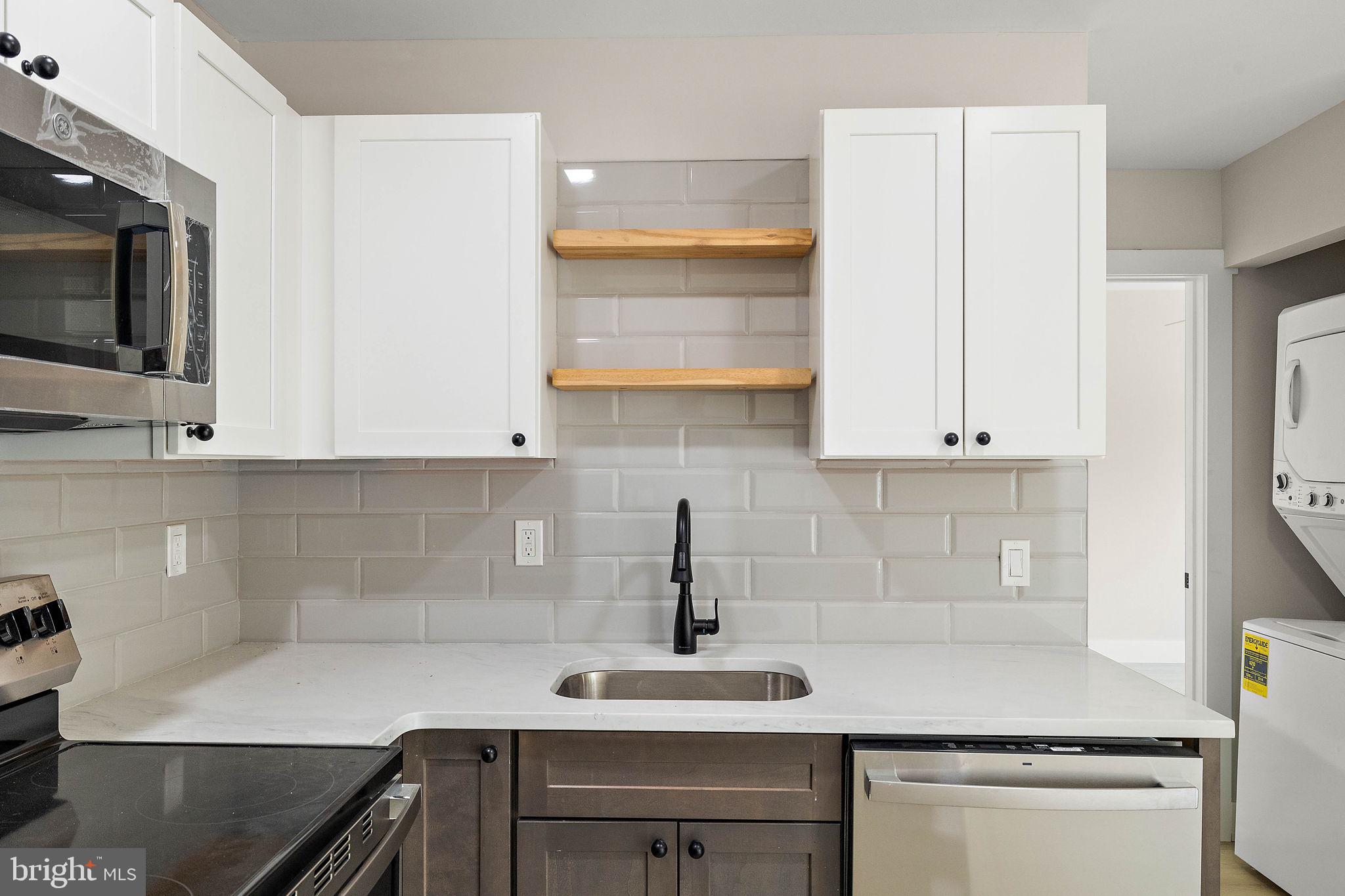 200 Brandywine Boulevard, Unit C7 Wilmington, DE 19803 - Photo 6 of 16 a kitchen with stainless steel appliances white cabinets and a sink