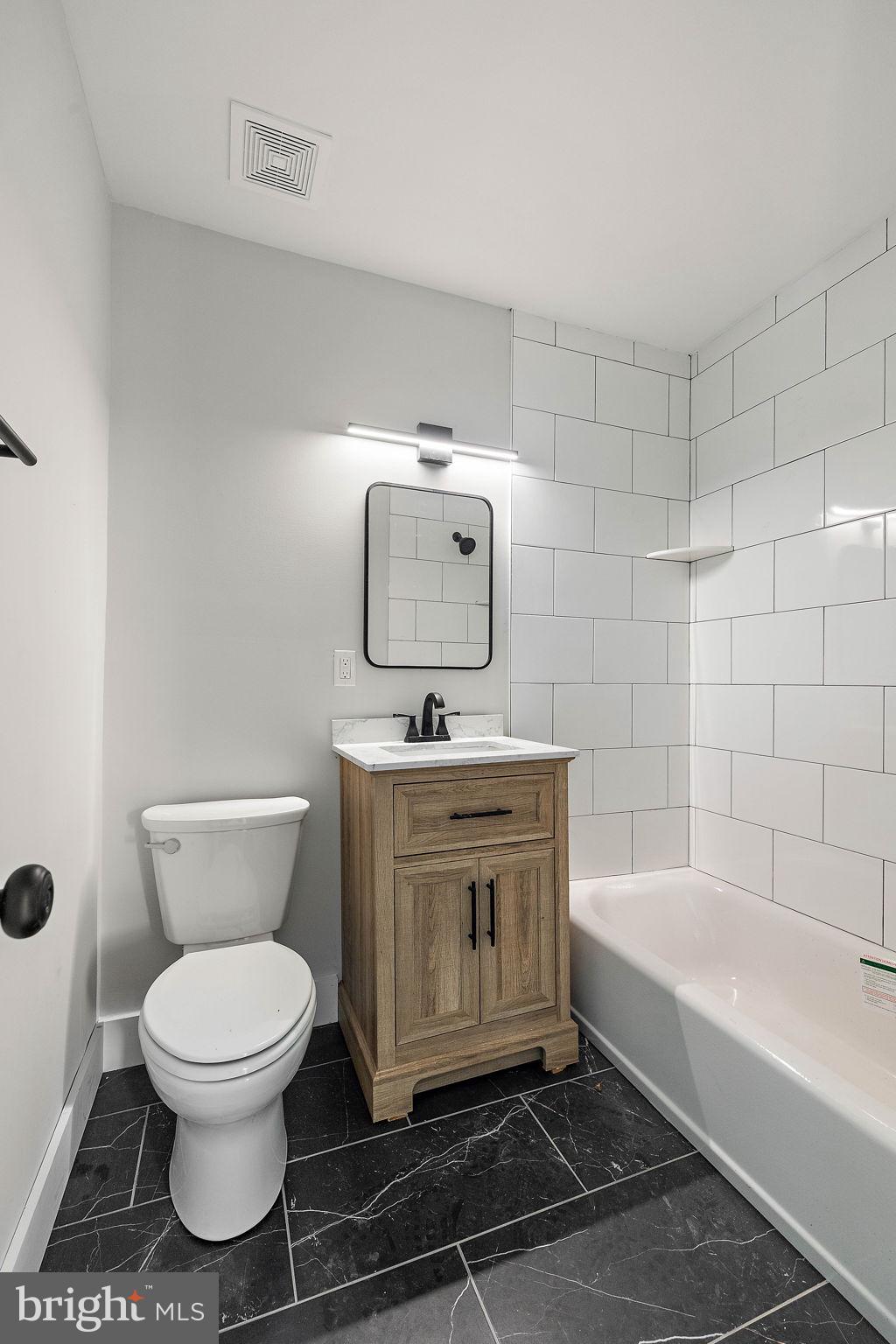 200 Brandywine Boulevard, Unit C7 Wilmington, DE 19803 - Photo 9 of 16 a bathroom with a toilet a sink and bathtub