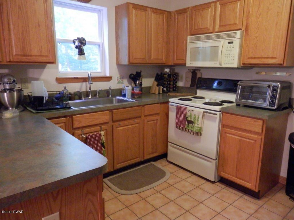 621 Silver Lake Road Dingmans Ferry, PA 18328 - Photo 12 of 14 a kitchen with a stove a sink and a cabinets