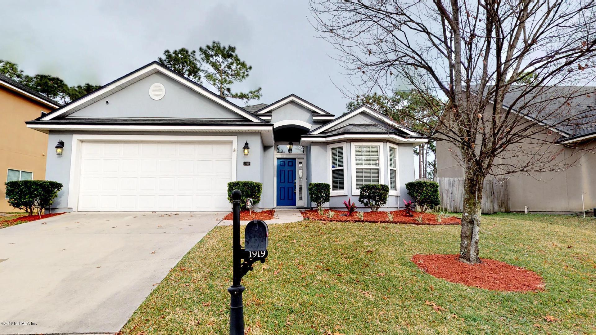 1919 Derringer Road Jacksonville, FL 32225 - Photo 1 of 42 a front view of a house with a yard table and chairs