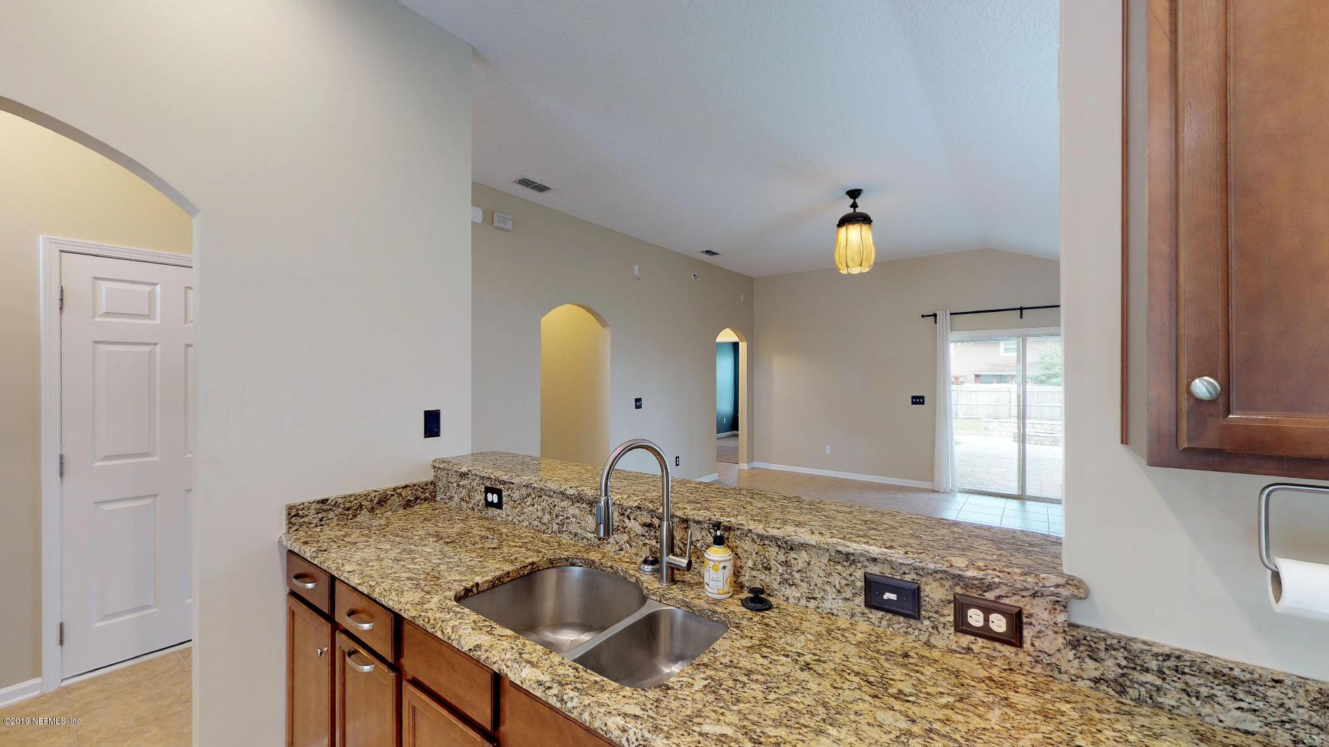 1919 Derringer Road Jacksonville, FL 32225 - Photo 11 of 42 a bathroom with a granite countertop sink and a mirror
