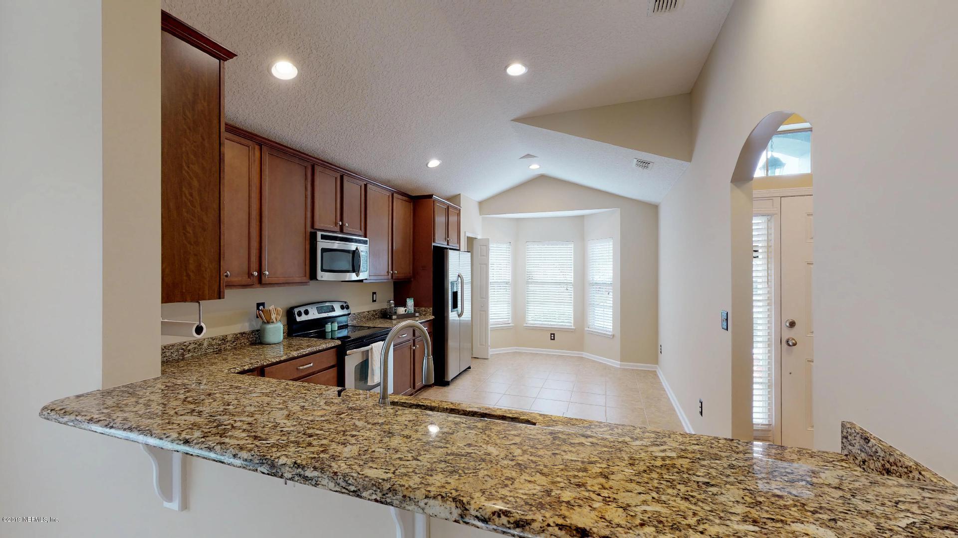 1919 Derringer Road Jacksonville, FL 32225 - Photo 12 of 42 a kitchen with stainless steel appliances granite countertop a sink stove and refrigerator