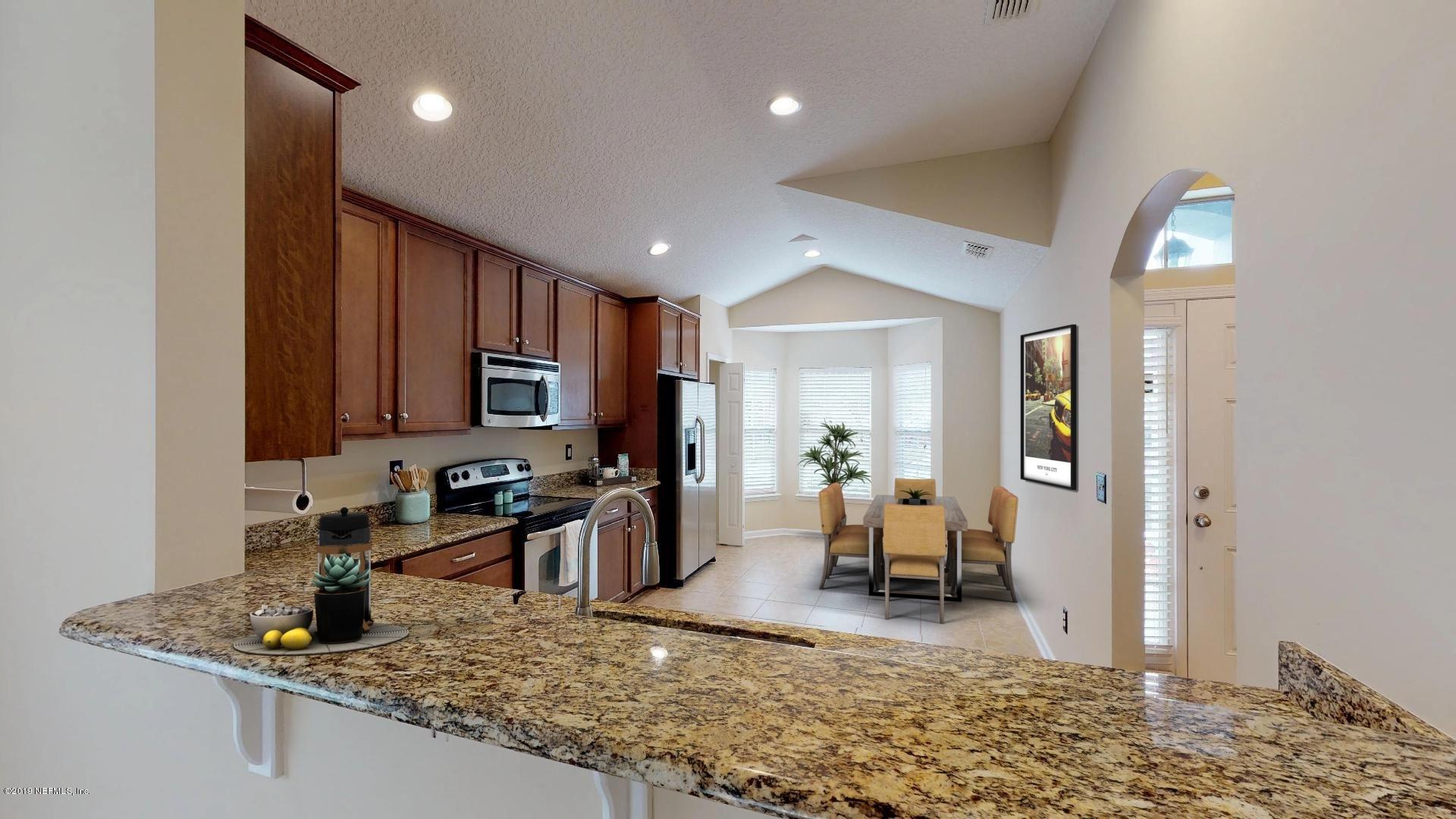 1919 Derringer Road Jacksonville, FL 32225 - Photo 13 of 42 a kitchen with a refrigerator and a sink