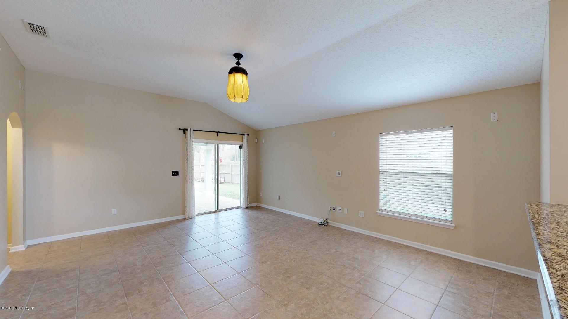 1919 Derringer Road Jacksonville, FL 32225 - Photo 17 of 42 an empty room with windows and mirror