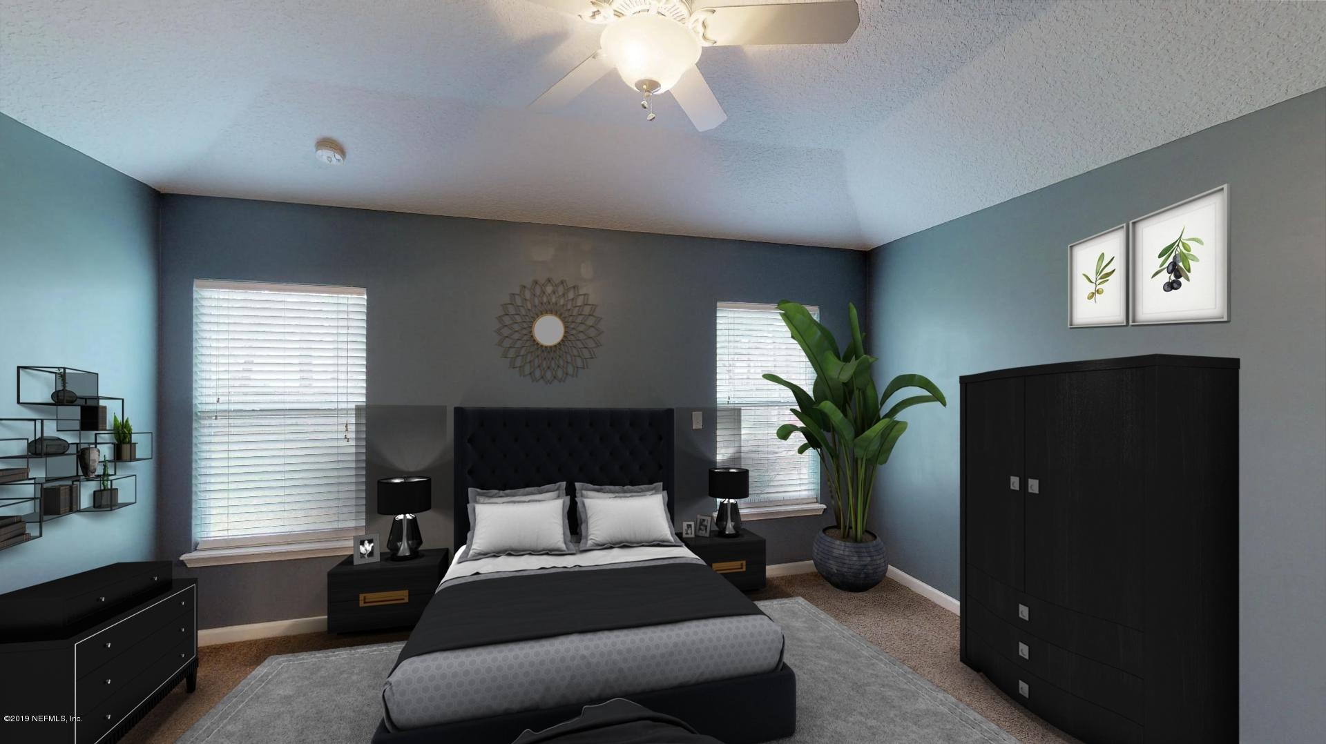 1919 Derringer Road Jacksonville, FL 32225 - Photo 21 of 42 a spacious bedroom with a bed and a chandelier