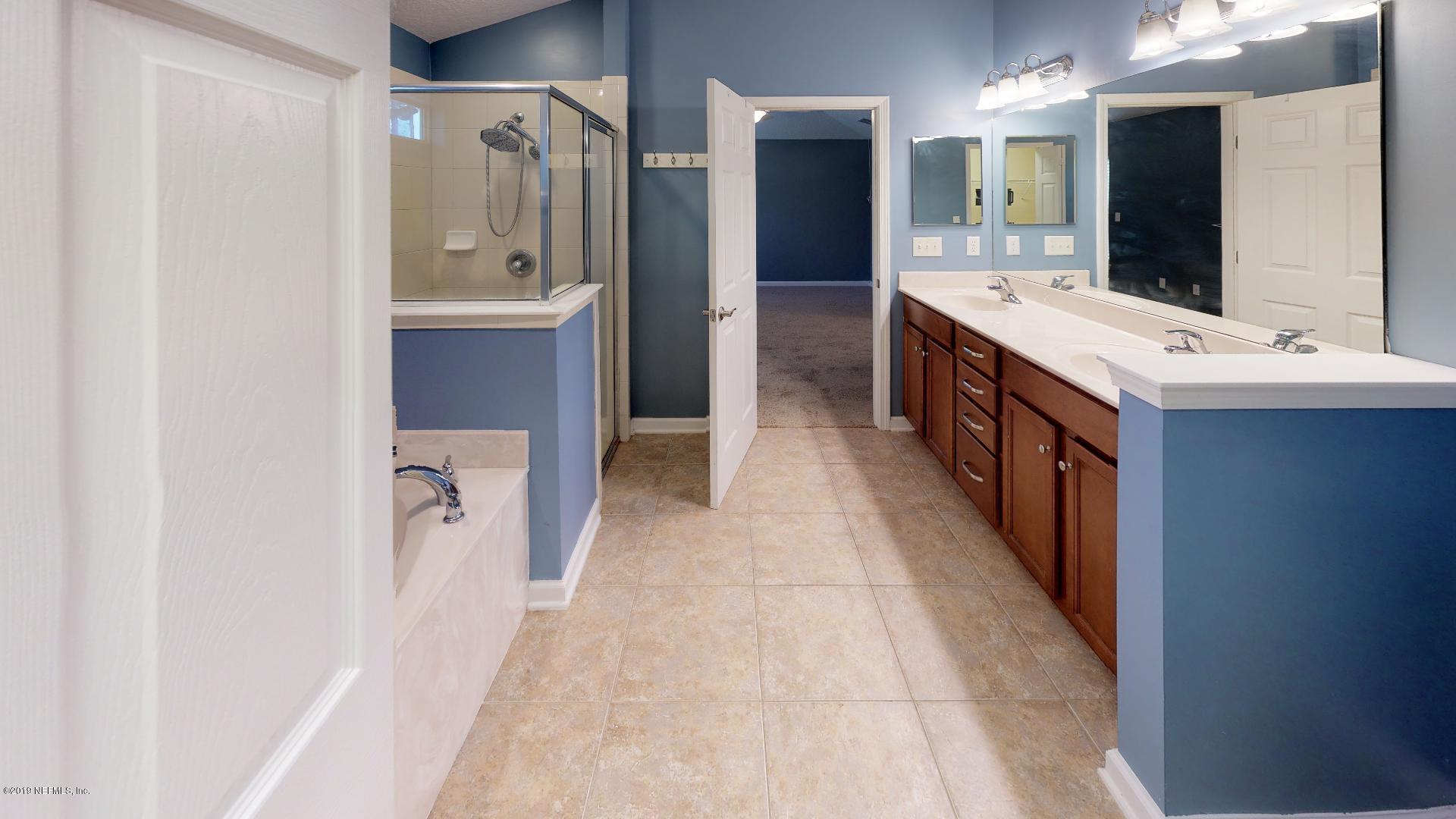 1919 Derringer Road Jacksonville, FL 32225 - Photo 22 of 42 a large bathroom with a double vanity sink mirror and shower