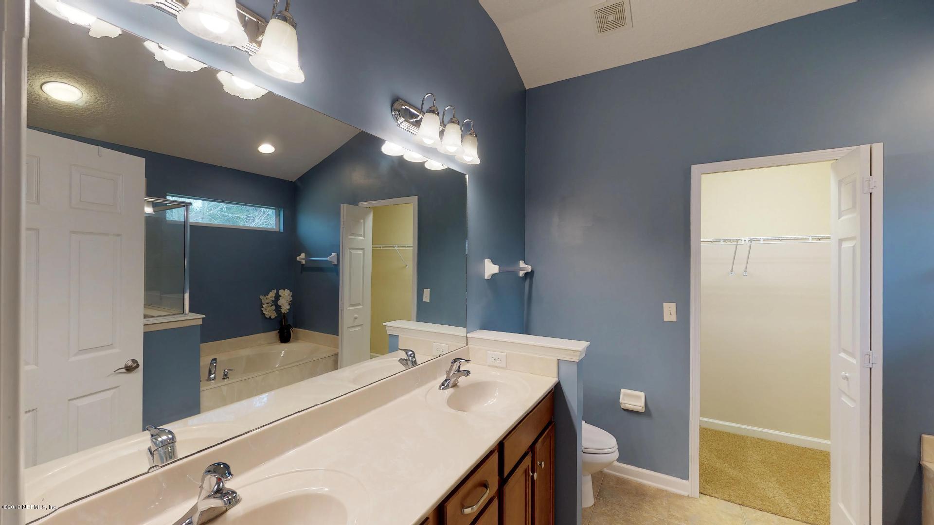 1919 Derringer Road Jacksonville, FL 32225 - Photo 23 of 42 a bathroom with a sink tub and a mirror
