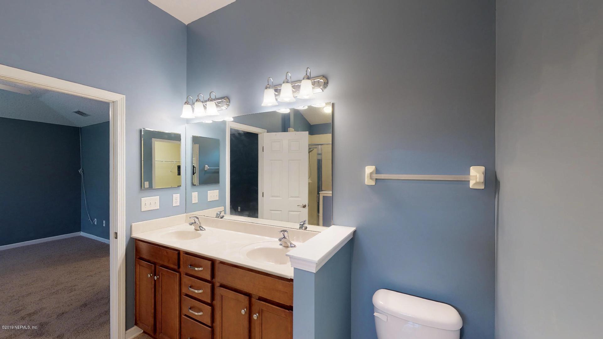 1919 Derringer Road Jacksonville, FL 32225 - Photo 24 of 42 a bathroom with a sink and a mirror