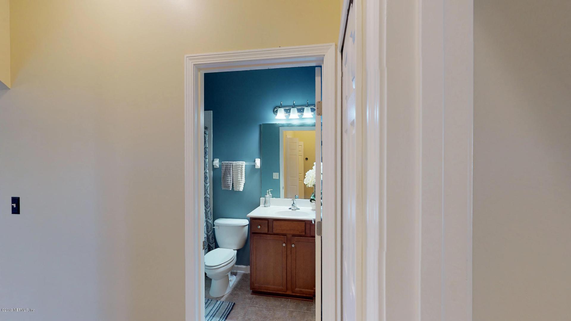 1919 Derringer Road Jacksonville, FL 32225 - Photo 26 of 42 a bathroom with a toilet sink and mirror