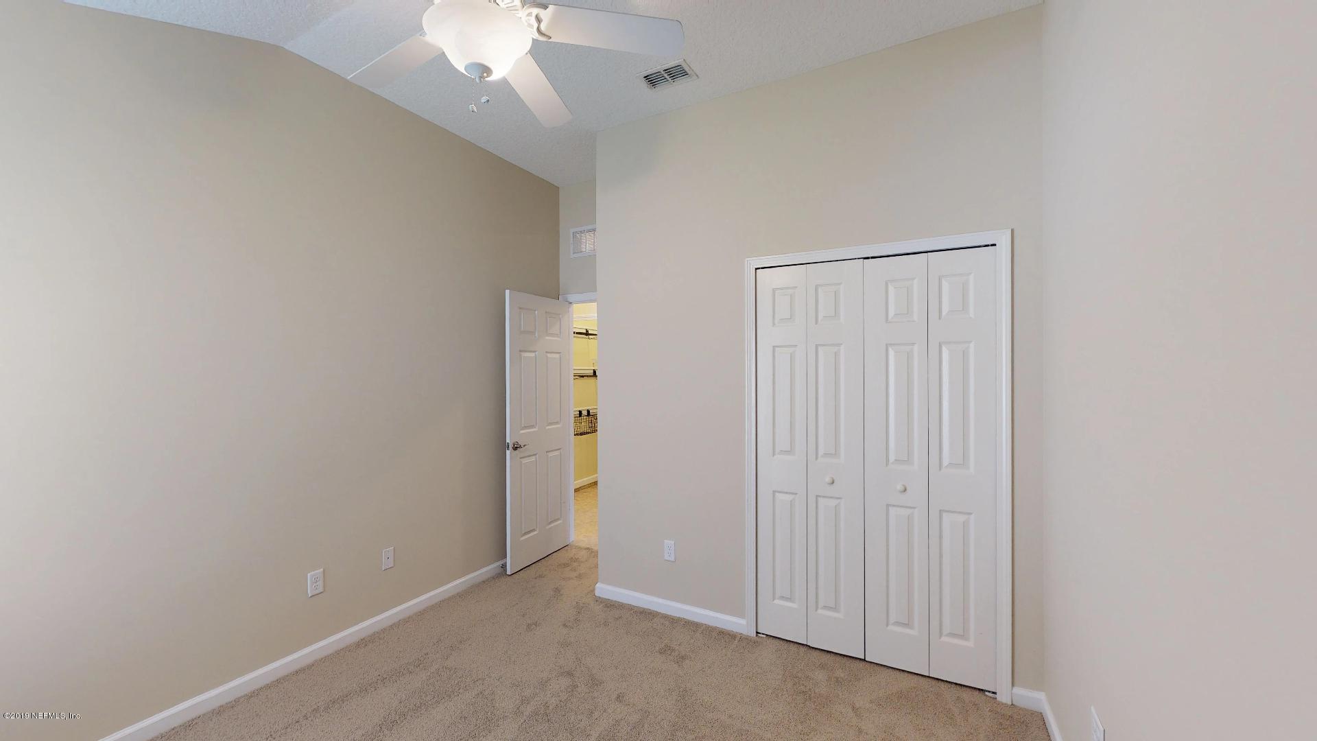 1919 Derringer Road Jacksonville, FL 32225 - Photo 30 of 42 an empty room with a chandelier fan and closet