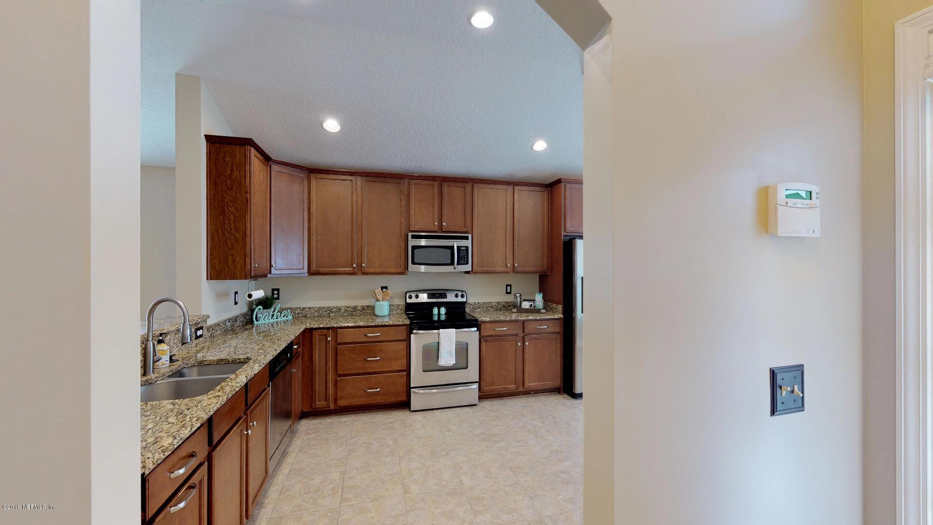 1919 Derringer Road Jacksonville, FL 32225 - Photo 6 of 42 a kitchen with stainless steel appliances granite countertop a sink stove and refrigerator