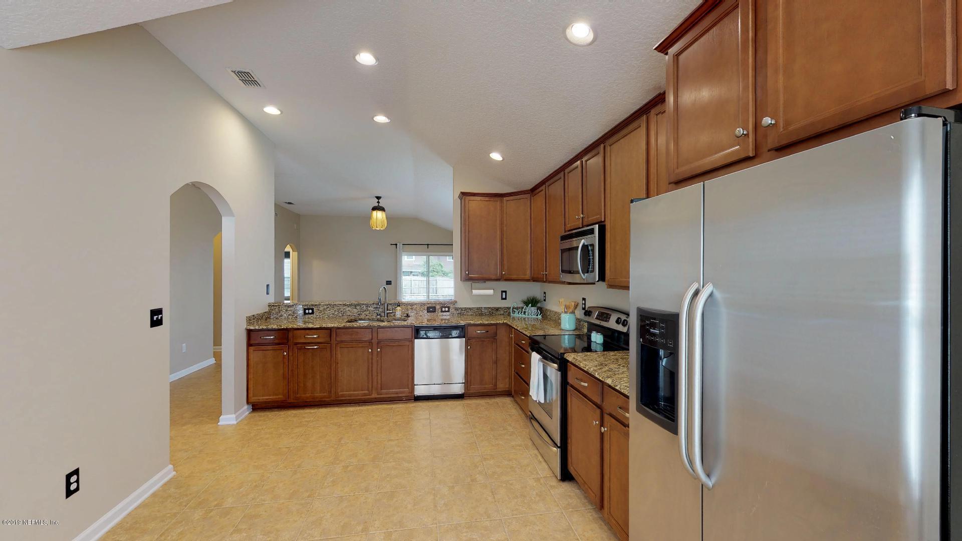 1919 Derringer Road Jacksonville, FL 32225 - Photo 10 of 42 a kitchen with stainless steel appliances granite countertop a refrigerator a stove and a sink