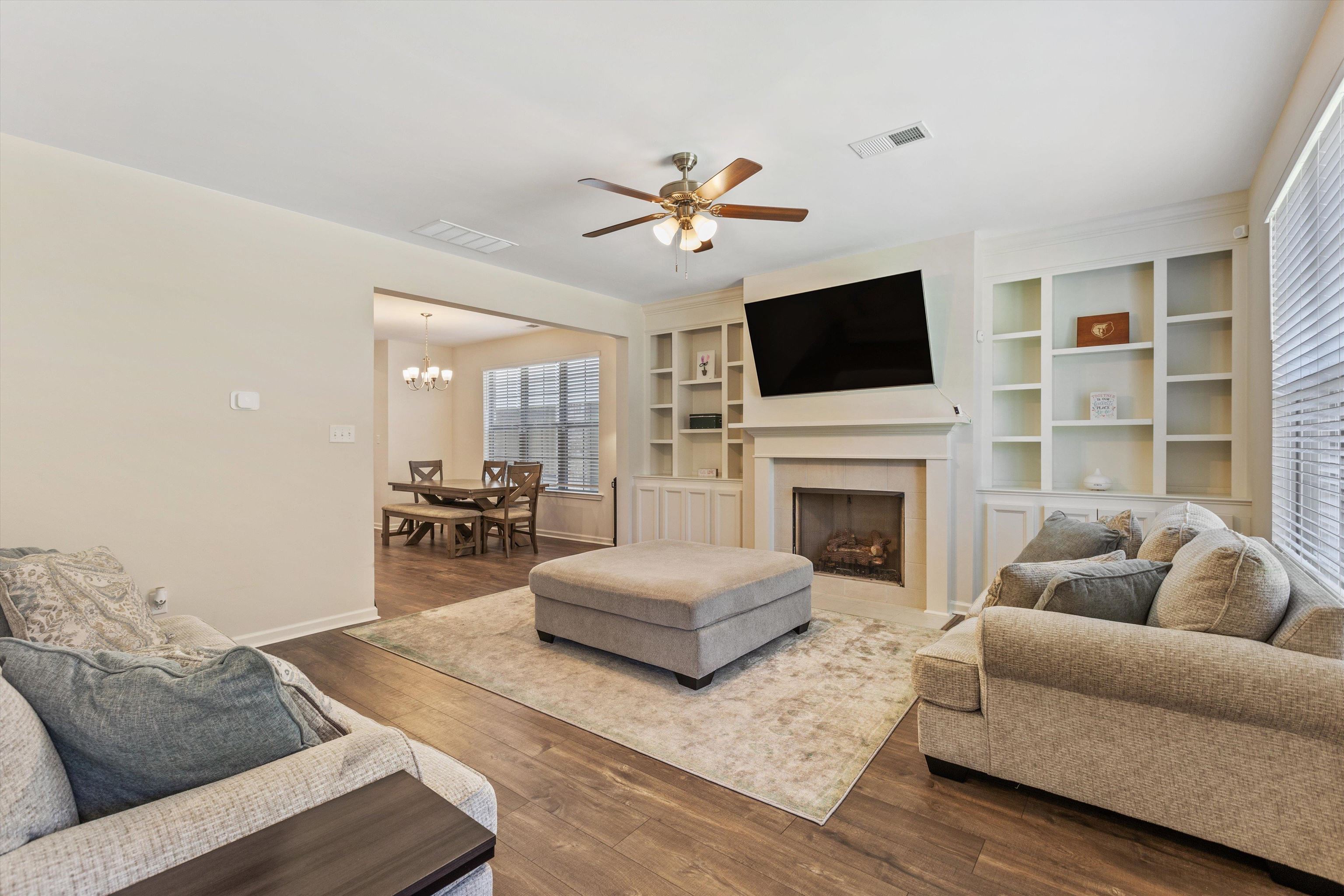 10139 Macon Road Cordova, TN 38018 - Photo 5 of 31 Living area featuring wood-finish flooring, a ceiling fan, and a fireplace with an integrated entertainment center