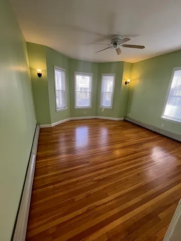 a view of room with window and wooden floor
