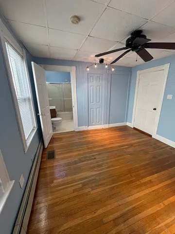 a view of a hallway with wooden floor