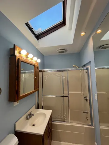 a bathroom with a sink and mirror