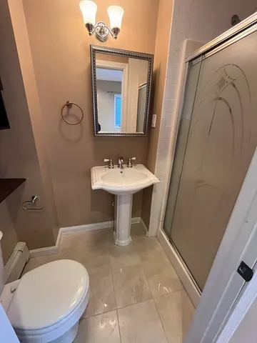 a bathroom with a toilet sink and mirror
