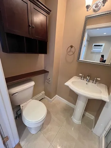 a bathroom with a sink a toilet and a mirror