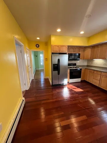 a kitchen with stainless steel appliances a refrigerator and a stove top oven
