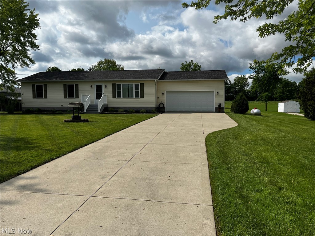 6876 Clark Road Atwater, OH 44201 - Photo 37 of 41 Ranch-style home featuring a front lawn and a garage