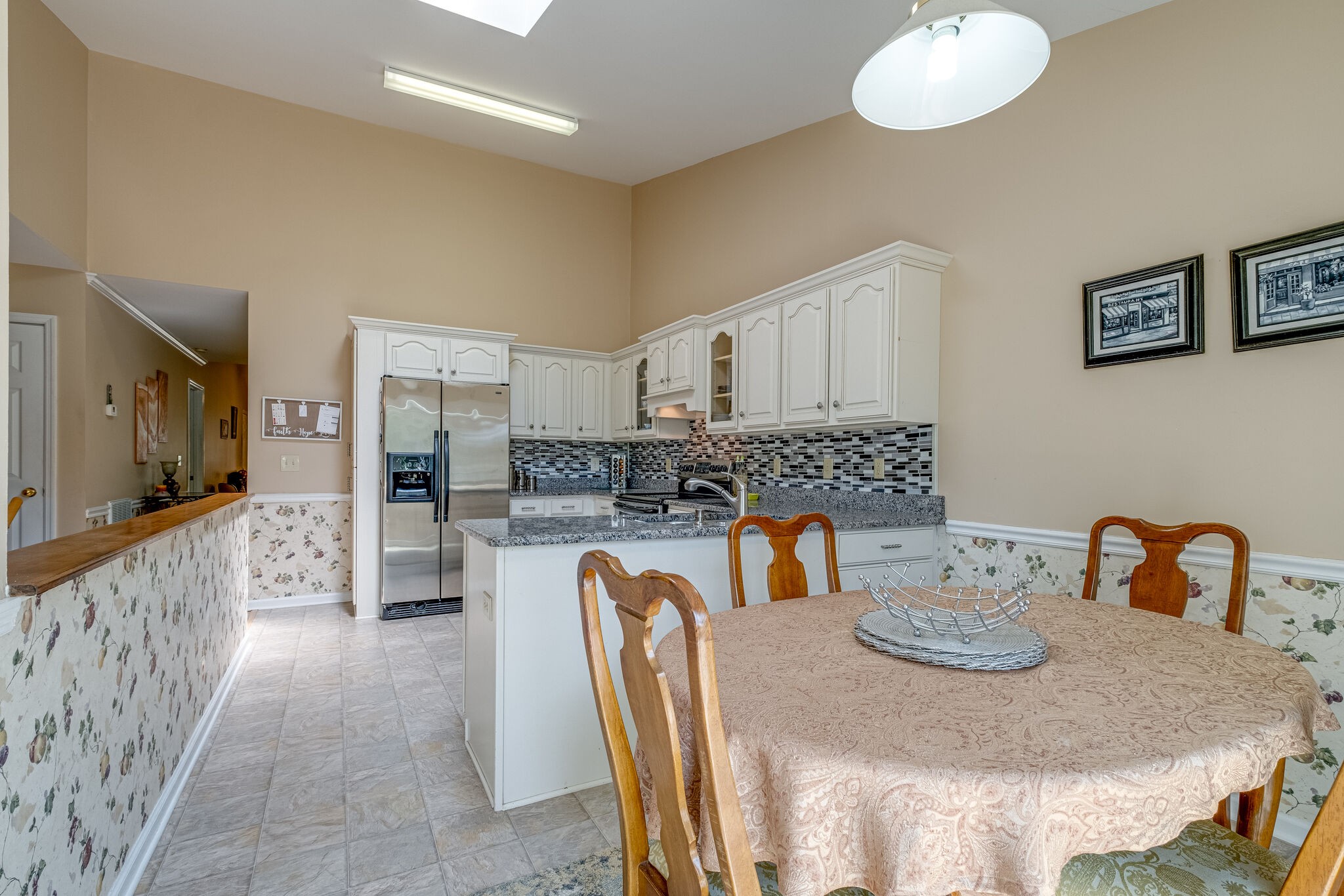 86 Pepper Ridge Circle, Unit 86 Antioch, TN 37013 - Photo 13 of 29 a kitchen with stainless steel appliances kitchen island granite countertop a table and chairs