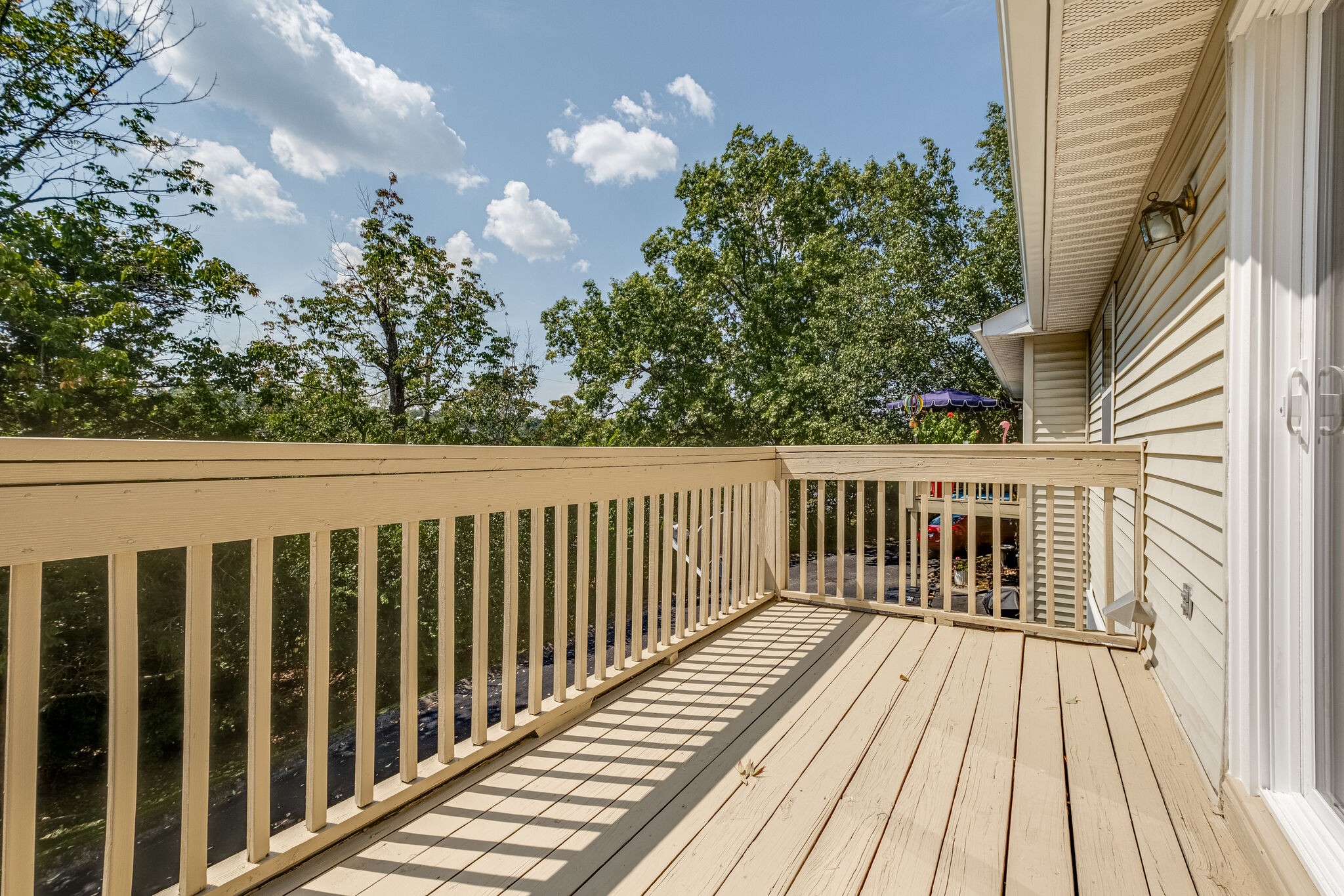 86 Pepper Ridge Circle, Unit 86 Antioch, TN 37013 - Photo 23 of 29 a balcony with wooden floor in front of it