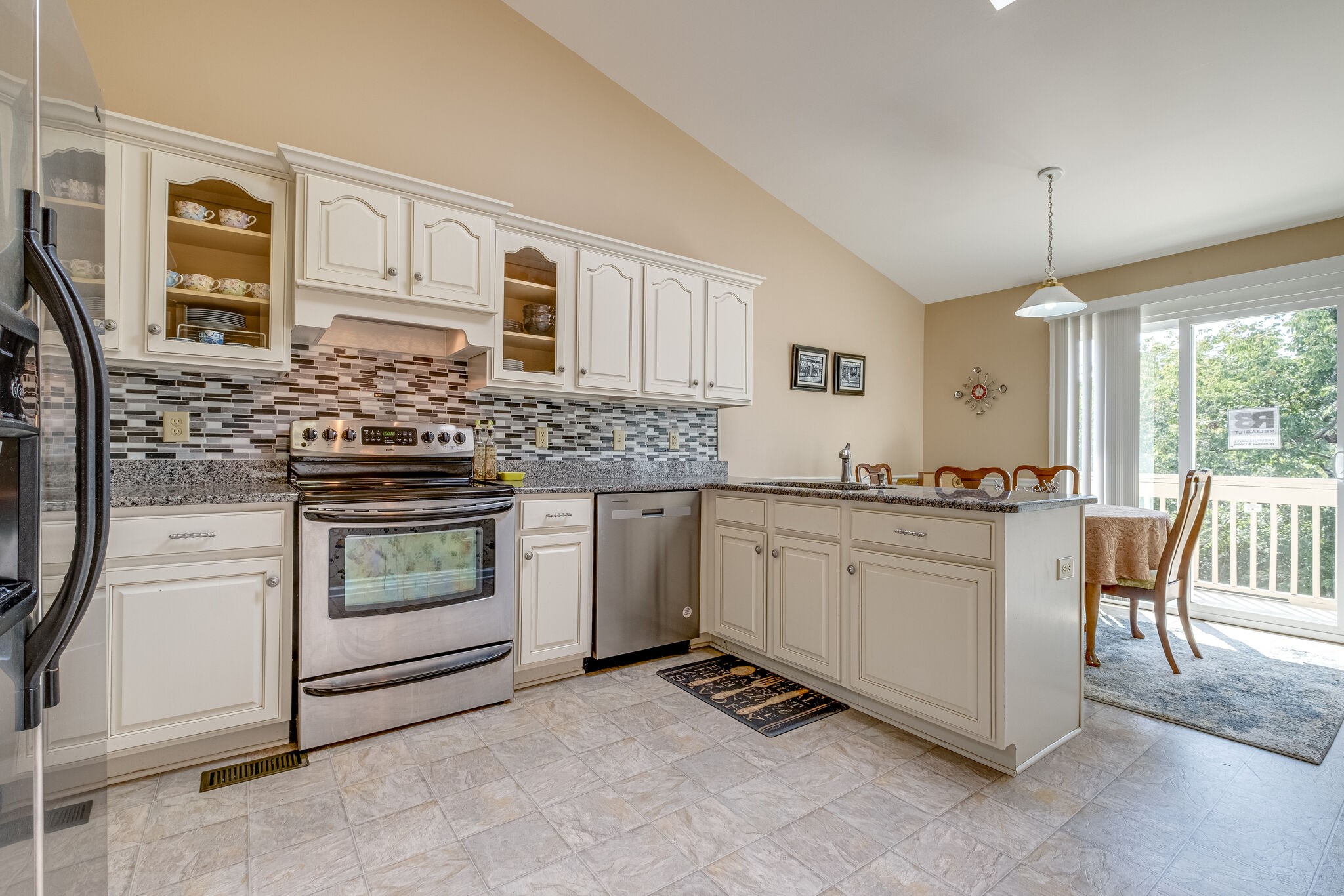 86 Pepper Ridge Circle, Unit 86 Antioch, TN 37013 - Photo 9 of 29 a kitchen with granite countertop white cabinets and white appliances