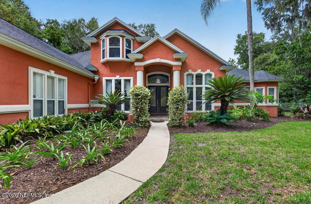 1483 Bridgette Way Fleming Island, FL 32003 - Photo 4 of 63 a front view of a house with garden