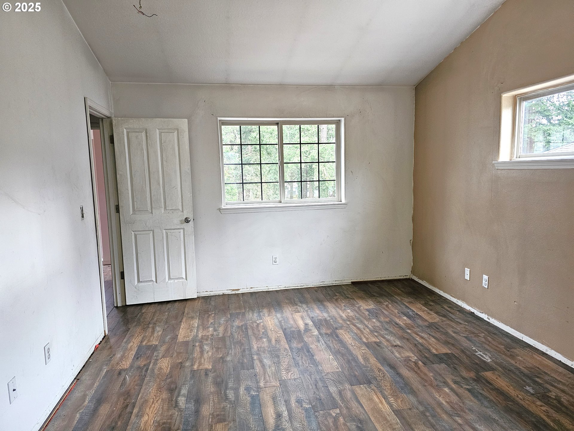 111 Northeast 149th Place Portland, OR 97230 - Photo 8 of 11 an empty room with wooden floor and windows