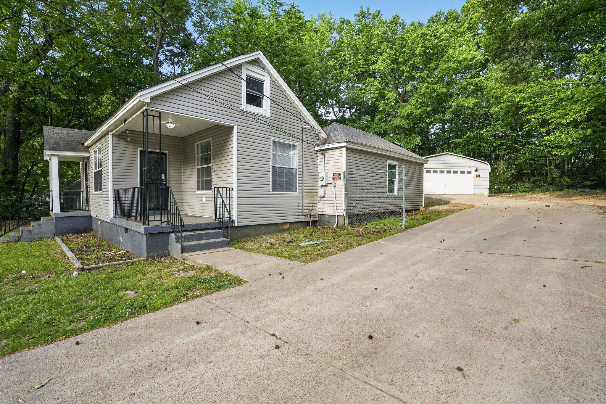 4199 Auburn Road Memphis, TN 38116 - Photo 1 of 32 Siding exterior with a covered front porch featuring wrought iron railings
