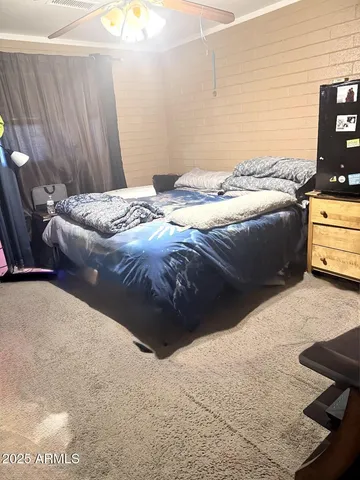 a bedroom with a bed and dresser