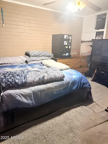 a bedroom with a bed and dresser