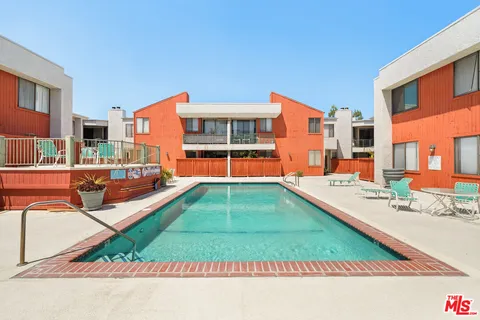 a backyard of a house with barbeque oven