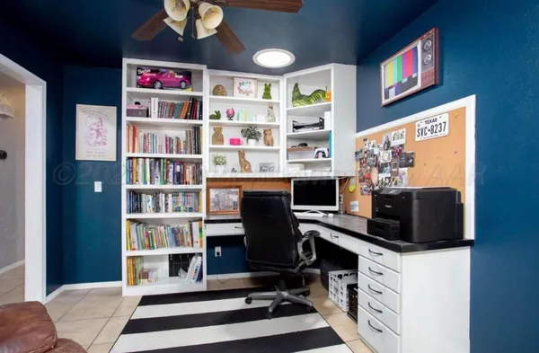 a bedroom with a workspace