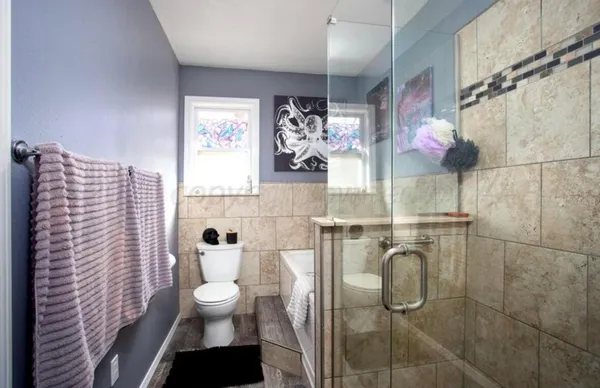 a bathroom with a bathtub and a toilet