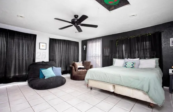 a bedroom with a bed mirror and window