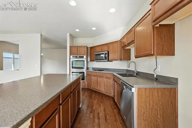 a kitchen with stainless steel appliances granite countertop a sink and stove