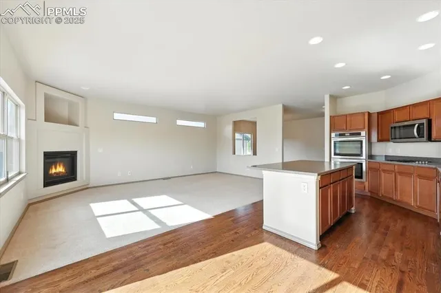 a large kitchen with stainless steel appliances granite countertop a large stove a sink and a oven