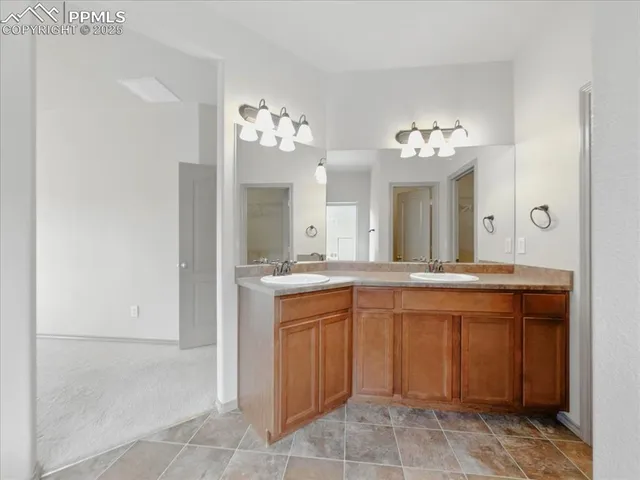 a spacious bathroom with a granite countertop sink a mirror and a