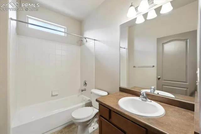 a bathroom with a sink a toilet a mirror a bathtub and shower